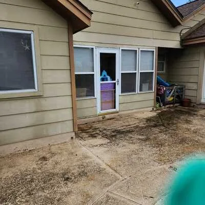 Patio before pressure washing — dirt stained concrete